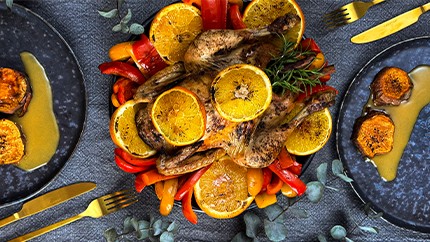 Coq à l'Orange with sweet potatoes and bell peppers vegetables